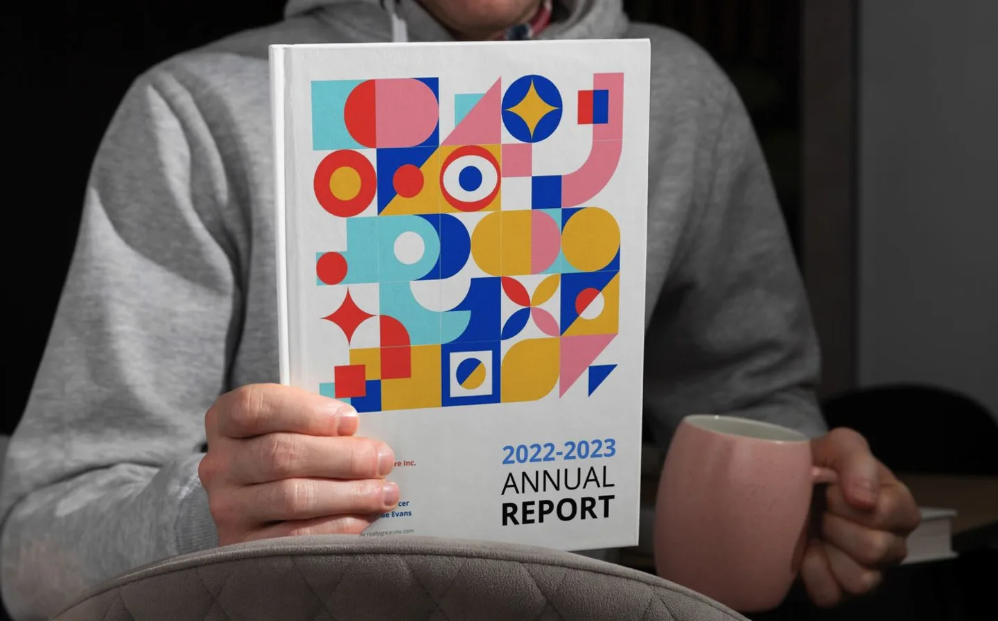 Man holding casebound annual report book