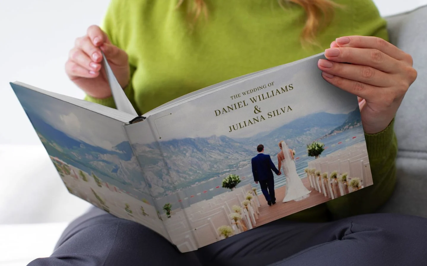 Woman looking through layflat photo book of a wedding